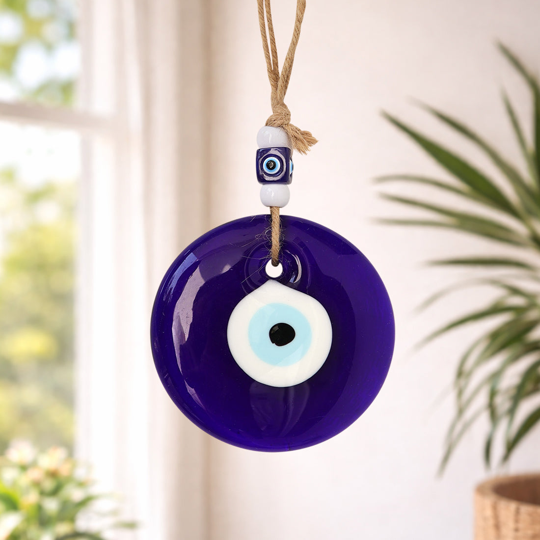 Evil Eye Wall Hanging against a blurred indoor
