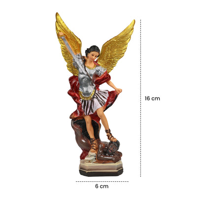 Decorative angel statue on a table with flowers and a candle in a living room setting